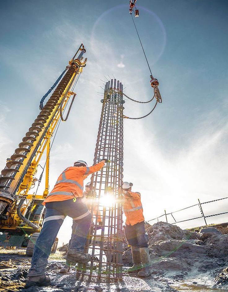 A team of engineers collaborating on a construction project plan